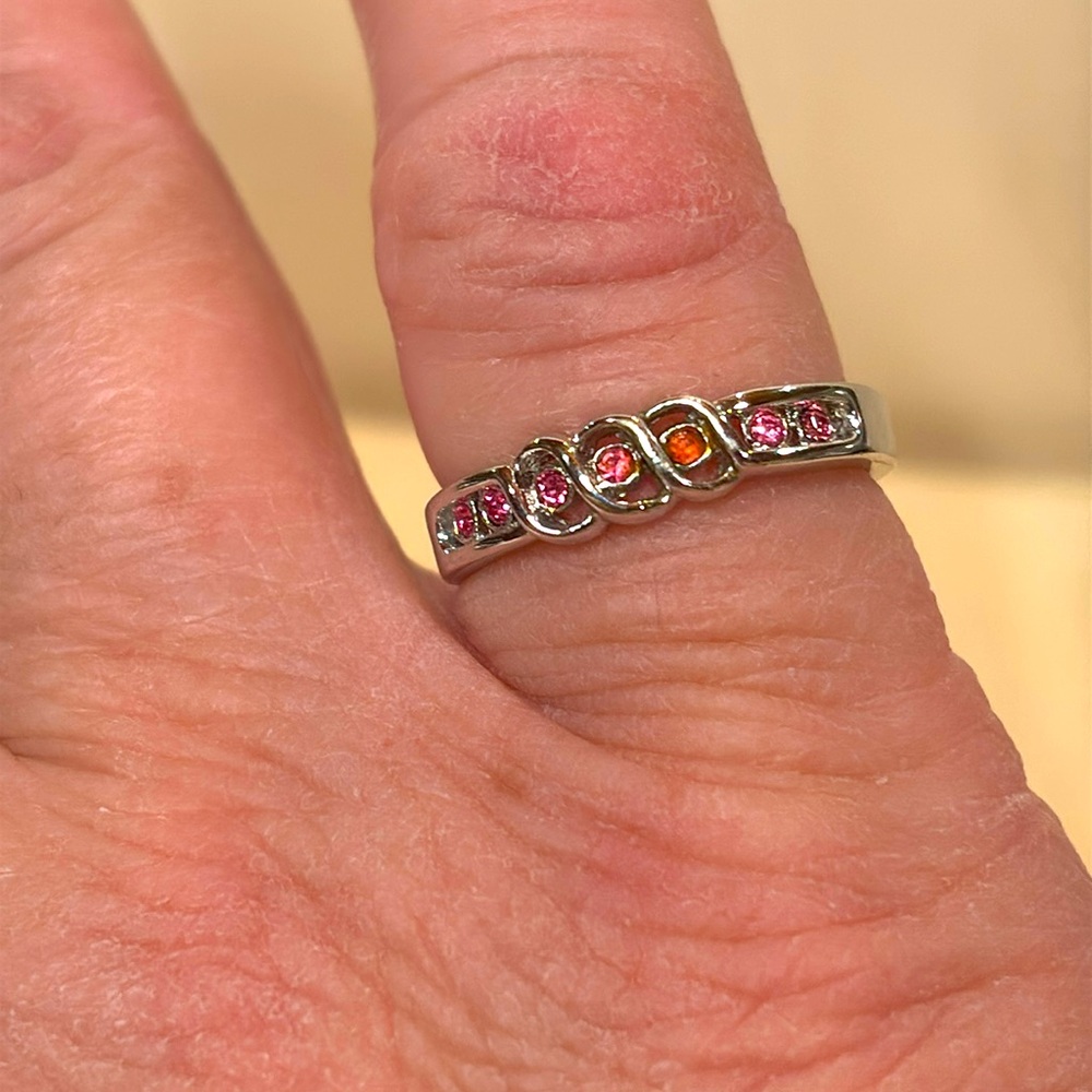 Ring size 6 silver toned with pink rhinestones. A very delicate looking. Pre-own